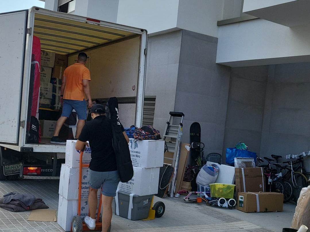 Carga de un camión de Mudanzas Colmenar frente a un edificio de viviendas